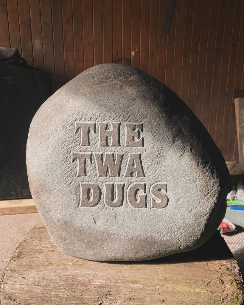 raised letters on a granite boulder